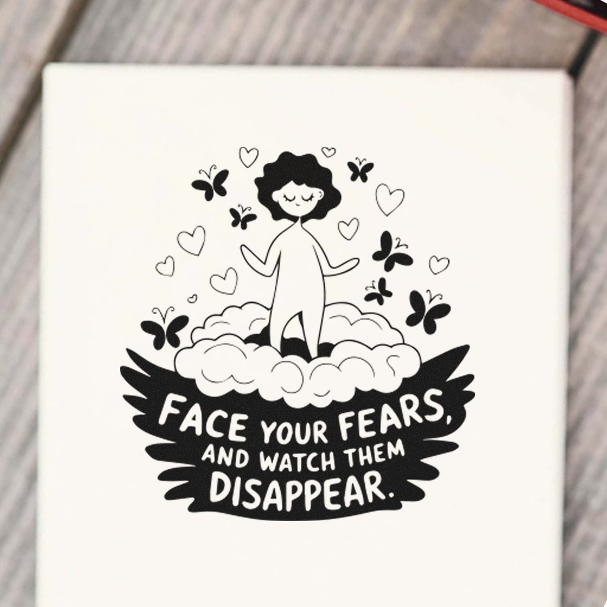 Black-and-white stamp and seal design with a woman, hearts and butterflies, and the quote Face your fears, and watch them disappear.