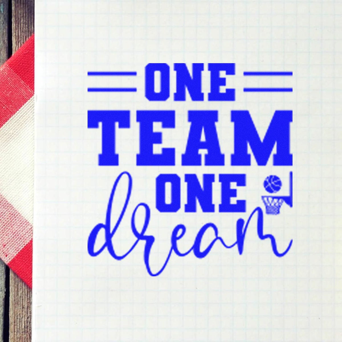 Blue custom stamp seal reading ONE TEAM ONE dream with basketball hoop icon on white grid paper, red striped edge.
