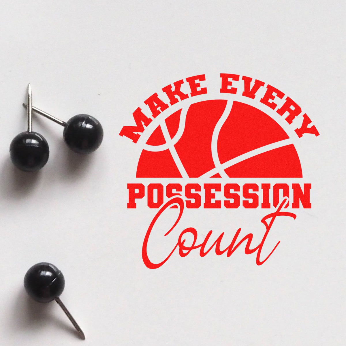 Black pushpins beside a red basketball stamp and seal reading Make Every Possession Count on white.