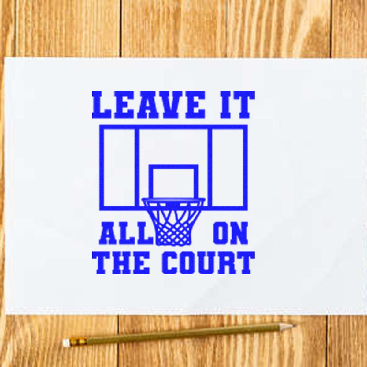 Blue basketball stamp seal with hoop and Leave It All on the Court on white paper, on a wood background.