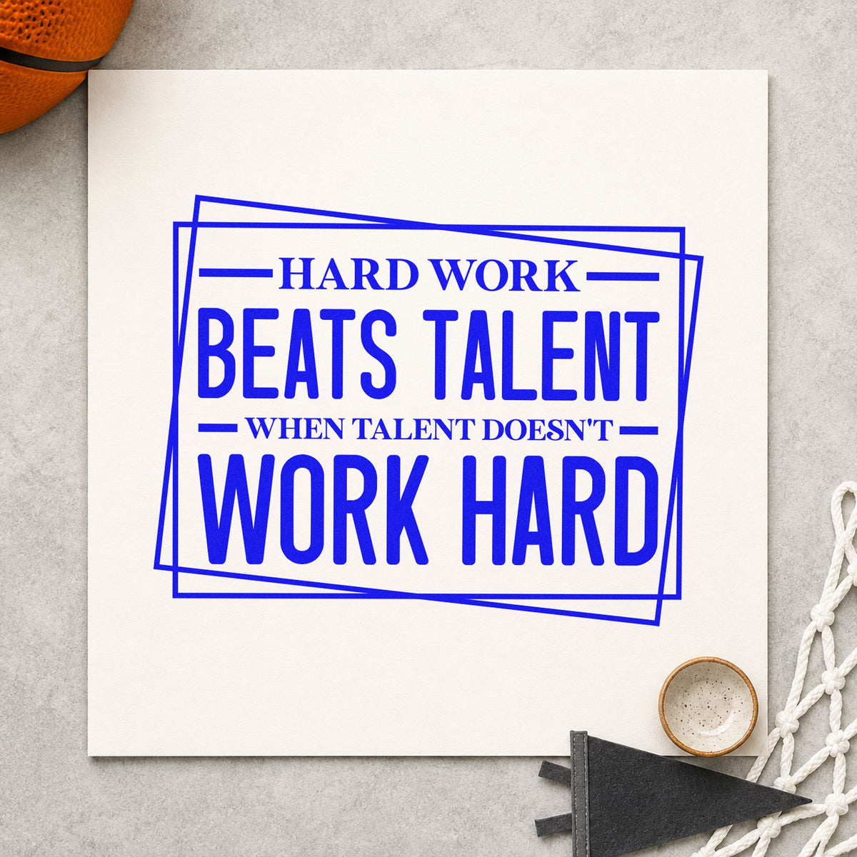 Hard Work Beats Talent craft stamp imprinted in blue ink on paper, a design suited to framed camp gym.