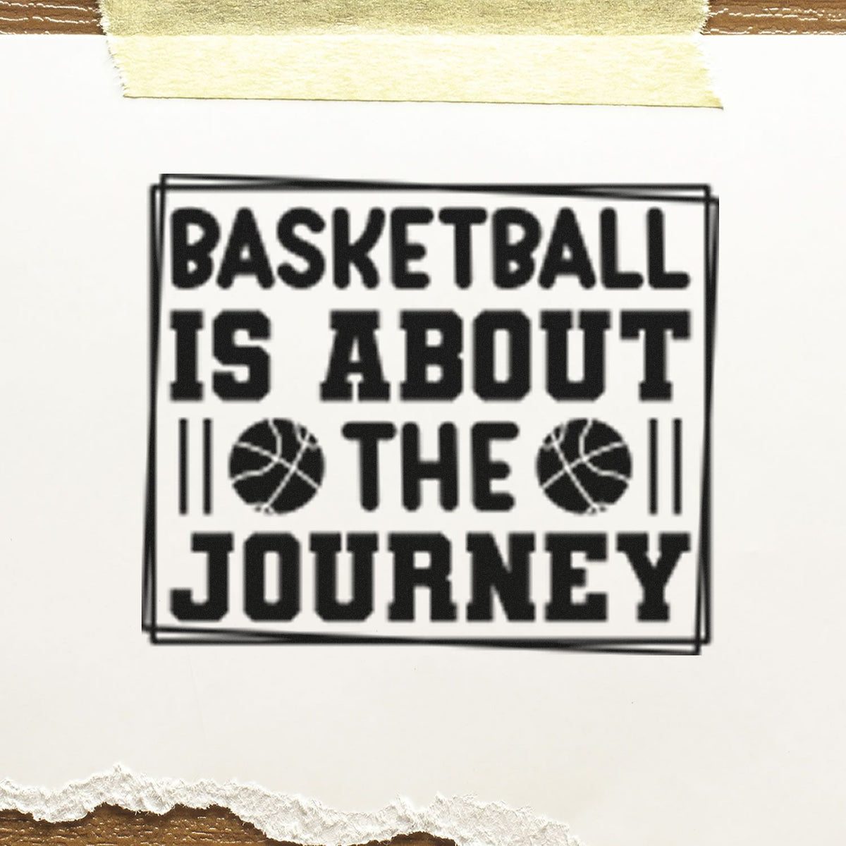 Black basketball stamp seal reading Basketball is about the journey, with two basketball icons on white paper.