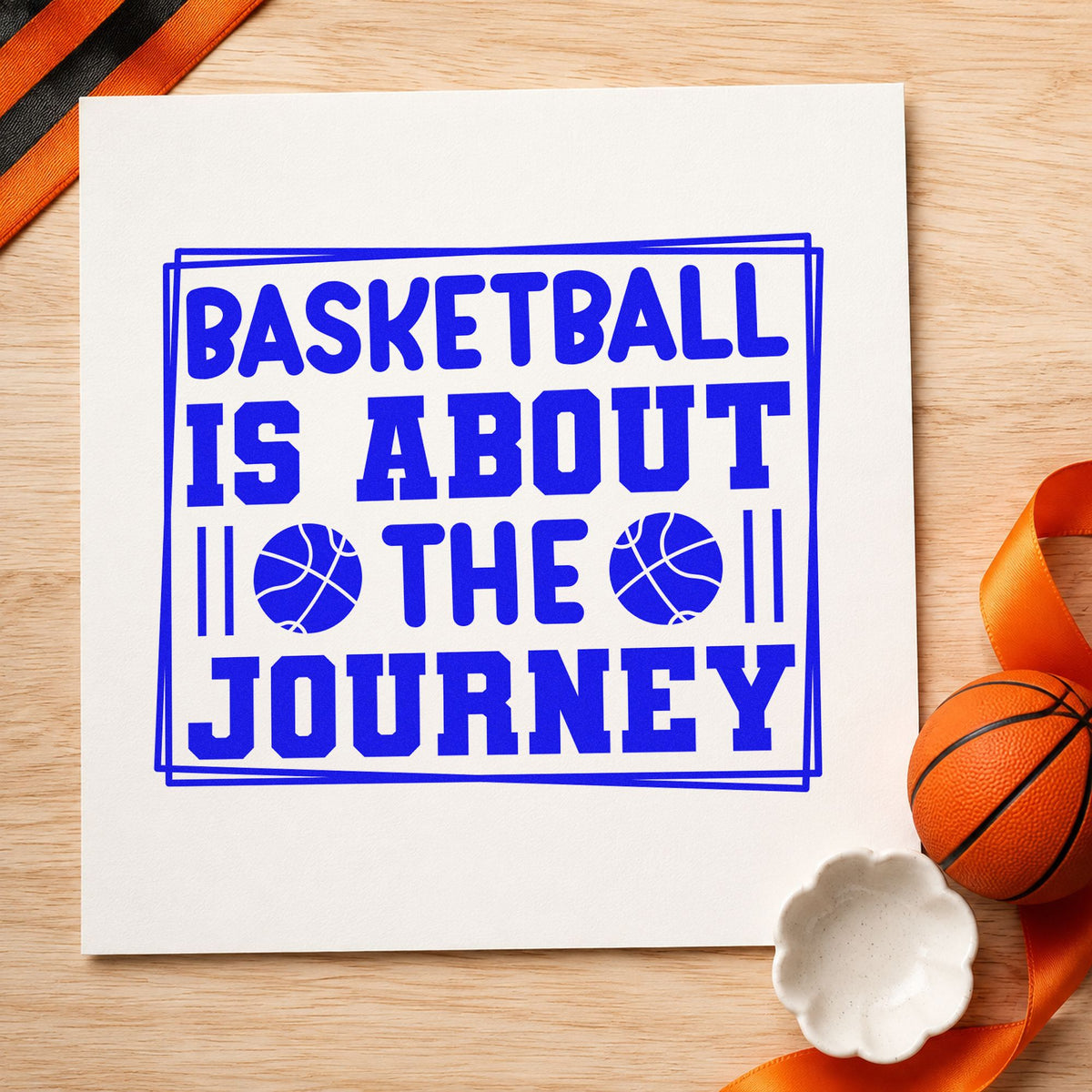 Basketball About The Journey craft stamp imprinted in blue ink on paper, a design suited to framed gym lobby.