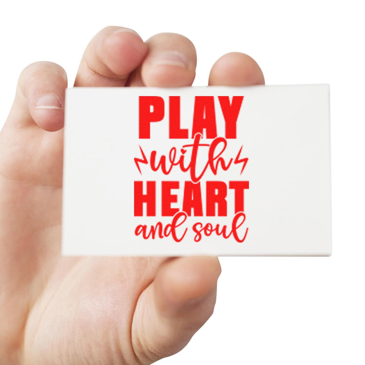 Hand holding a white stamp seal with bold red Play with heart and soul lettering.
