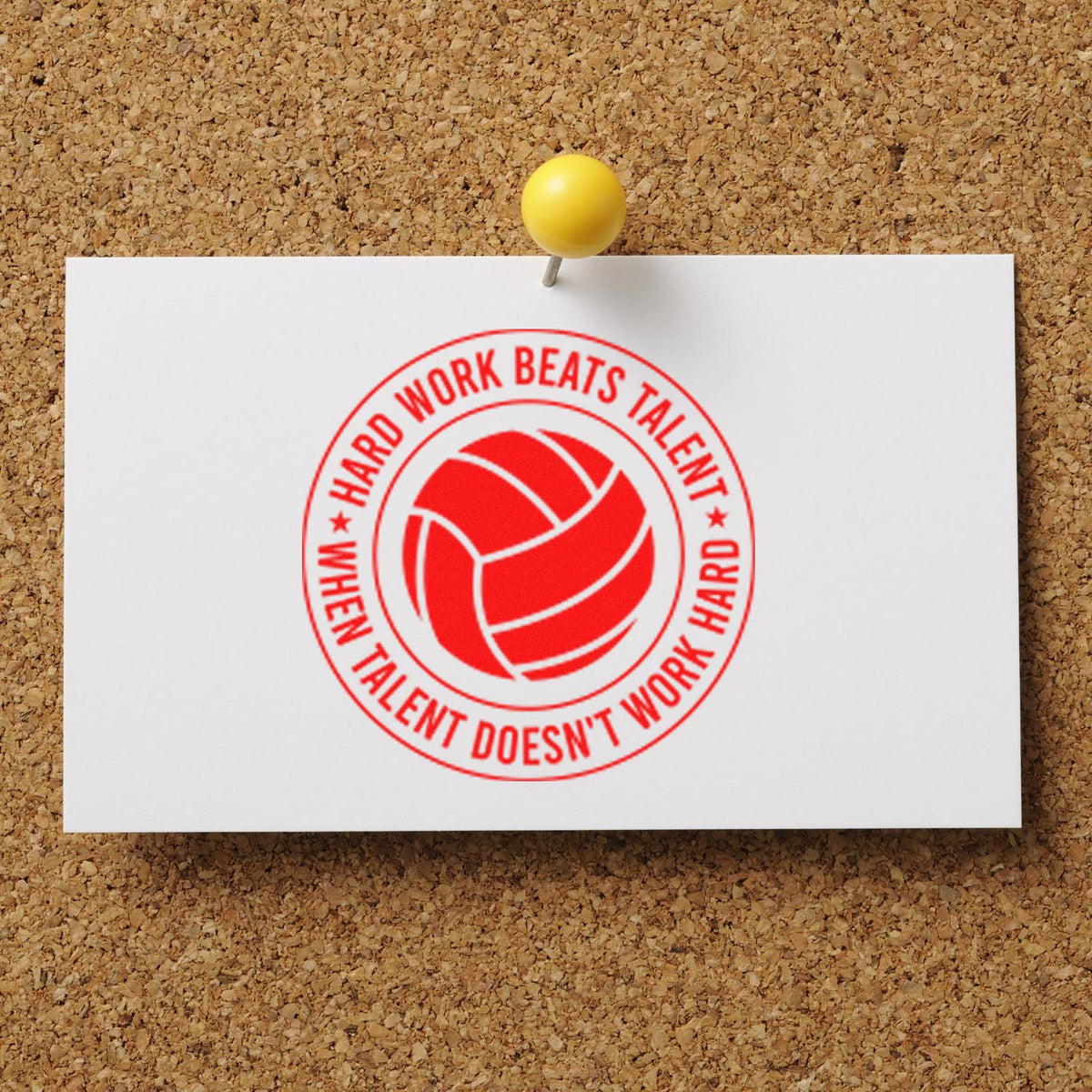 Red circular stamp seal with volleyball and Hard work beats talent on white card, pinned to corkboard with yellow tack.
