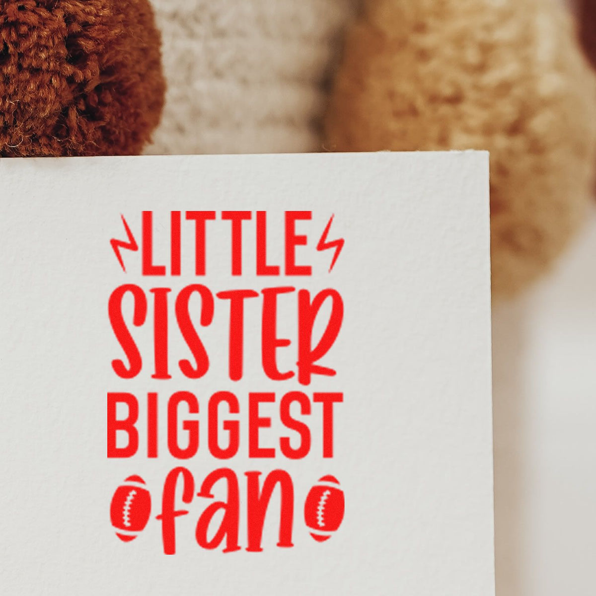 Red Little Sister Biggest Fan stamp on white card with football icons, for stamp and seal products.