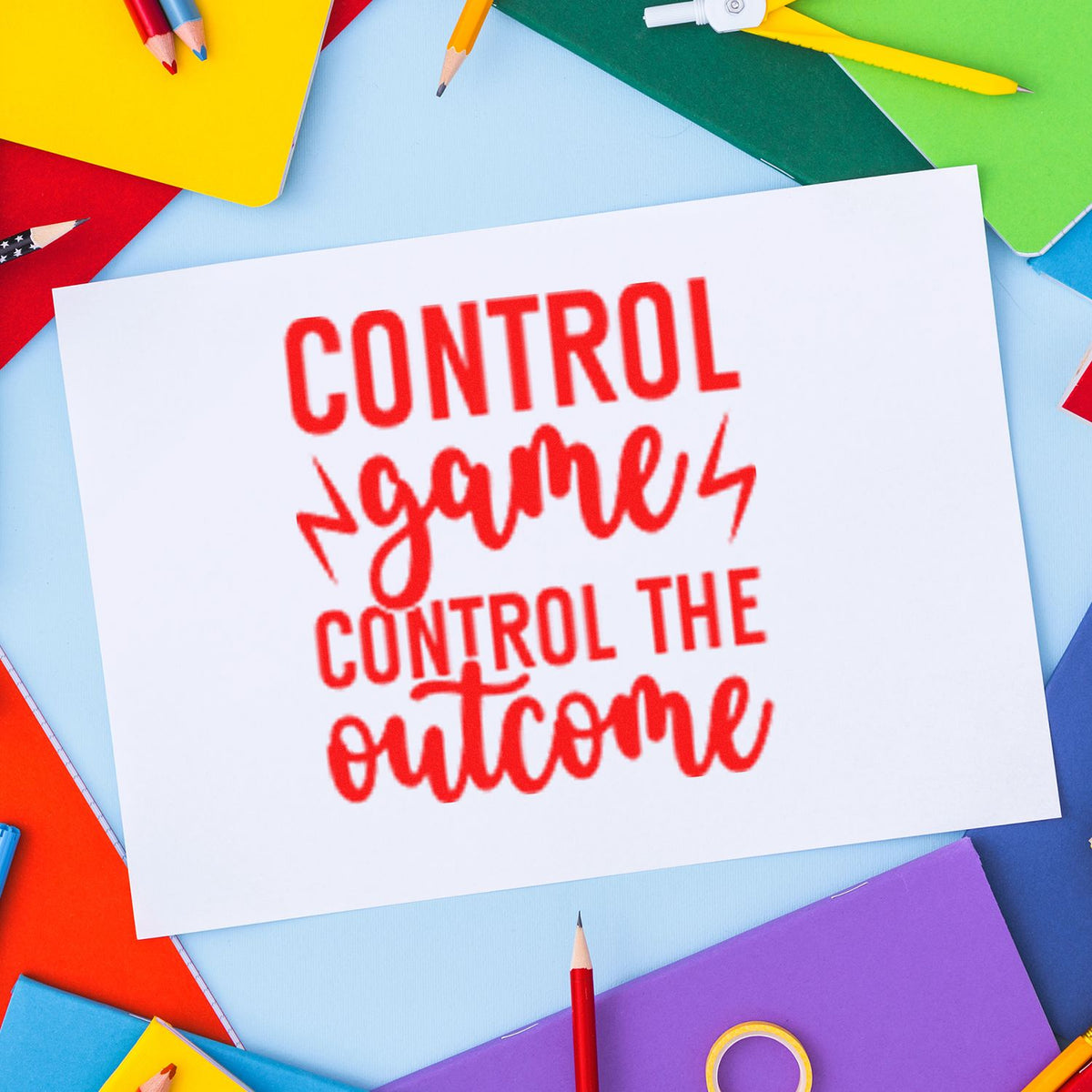 Red control stamp on white paper, surrounded by colorful notebooks and pencils; stamp and seal product display.