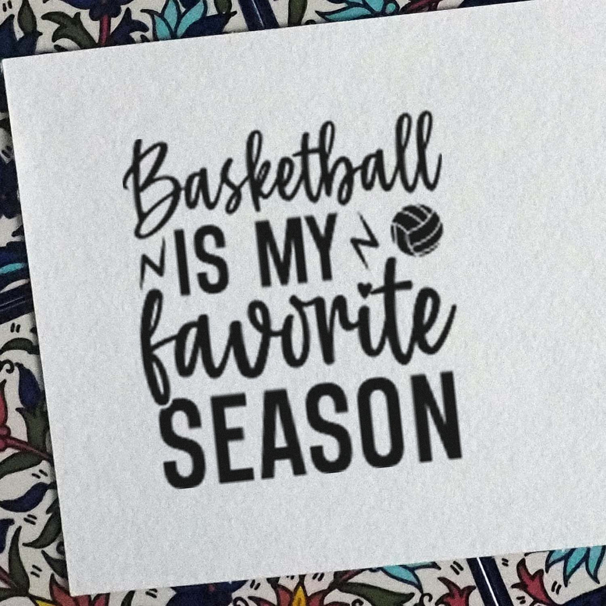 Black basketball-themed stamp seal on white paper, reading Basketball is my favorite season, with a ball icon.