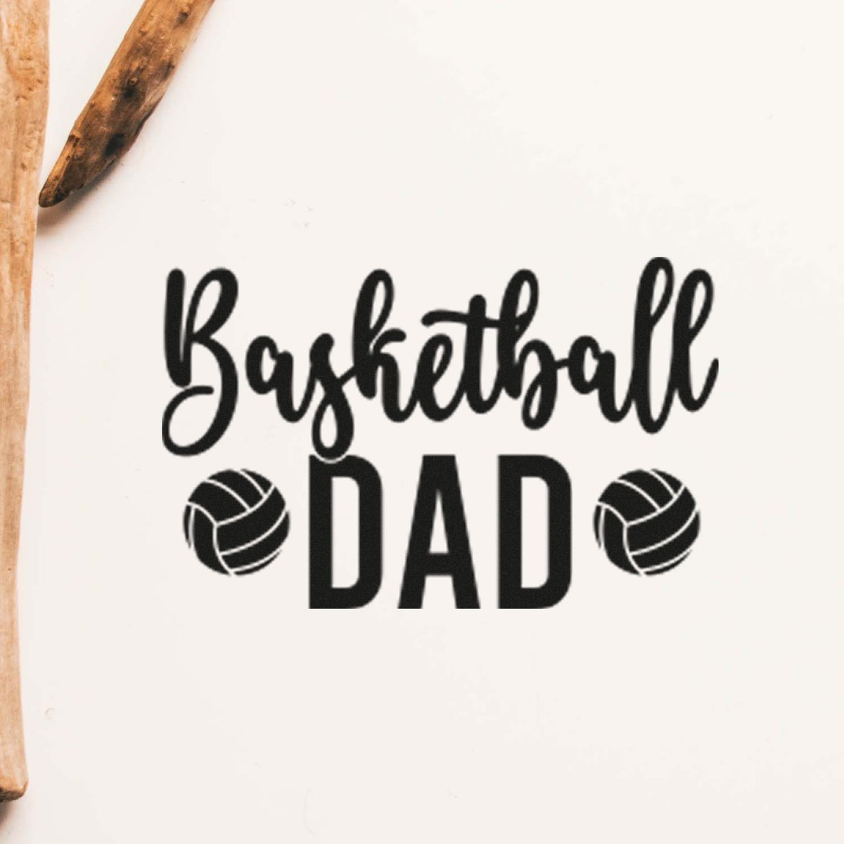 Basketball Dad black stamp design with two basketball icons on white background, beside wooden seal handles.