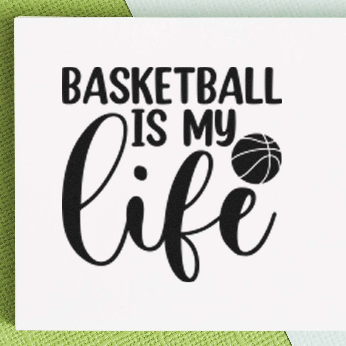 Black basketball stamp and seal reading Basketball is my life with basketball icon on white background.
