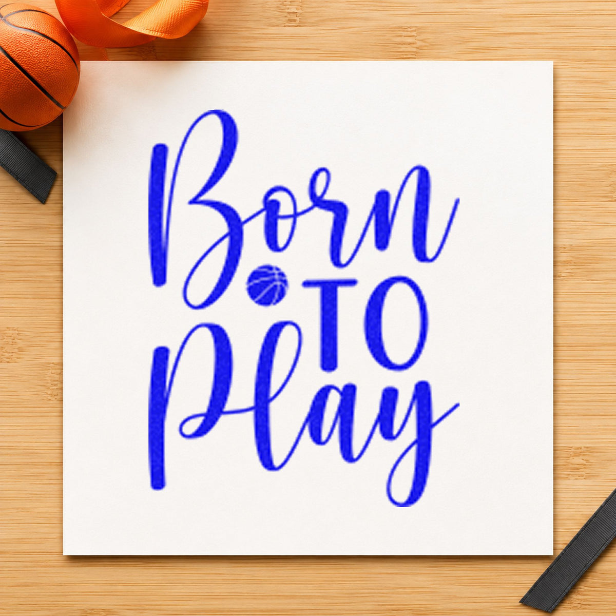 Born To Play Basketball craft stamp in blue ink on cardstock, an easy option for onesie panel printing.