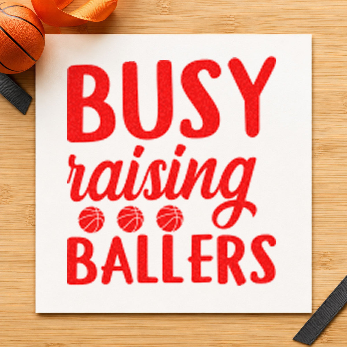 Busy Raising Ballers Quote craft stamp imprint in red ink on a handmade project, one idea being week plan cards.