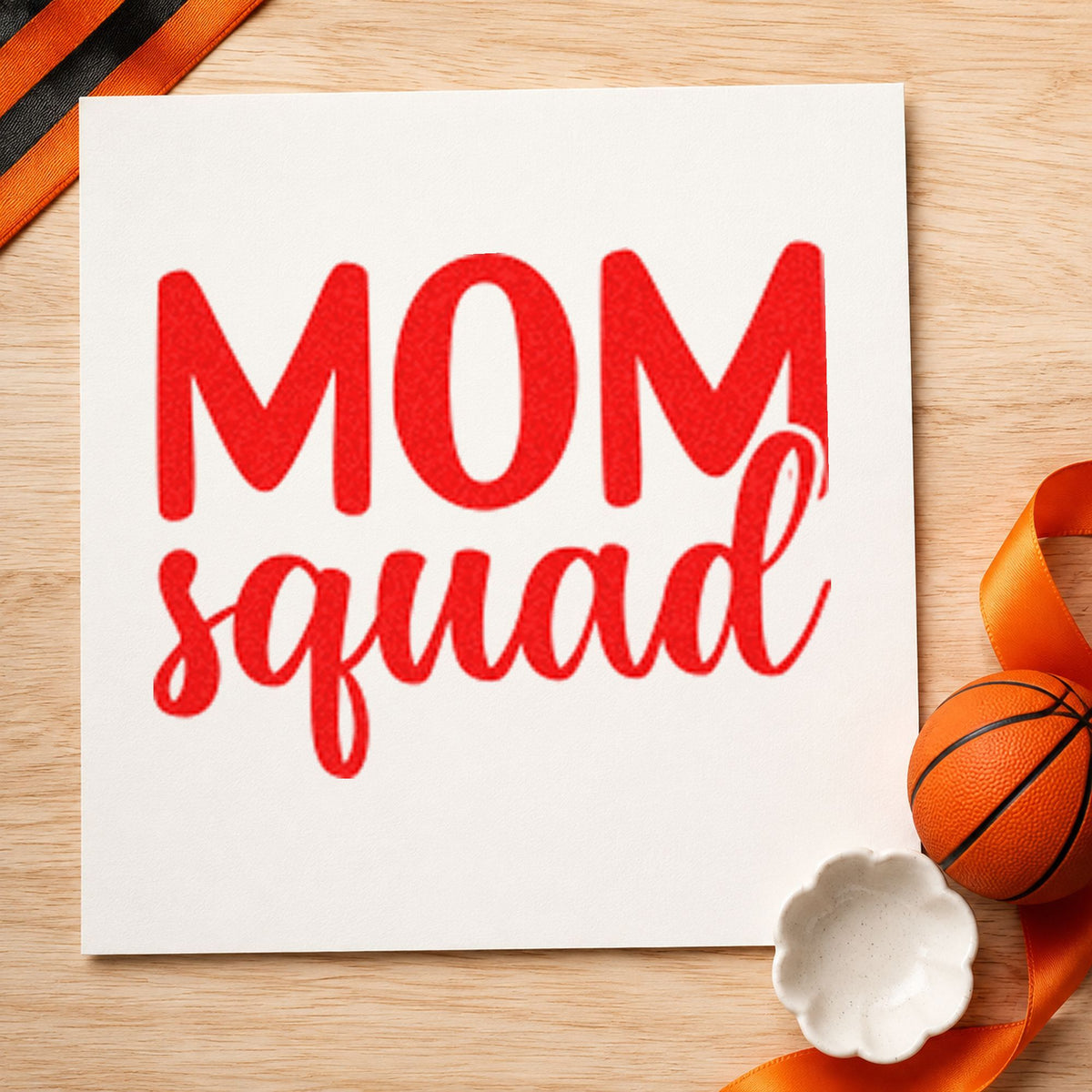 Mom Squad Bold Script craft stamp imprint in red ink on a handmade project, one idea being game plan cards.