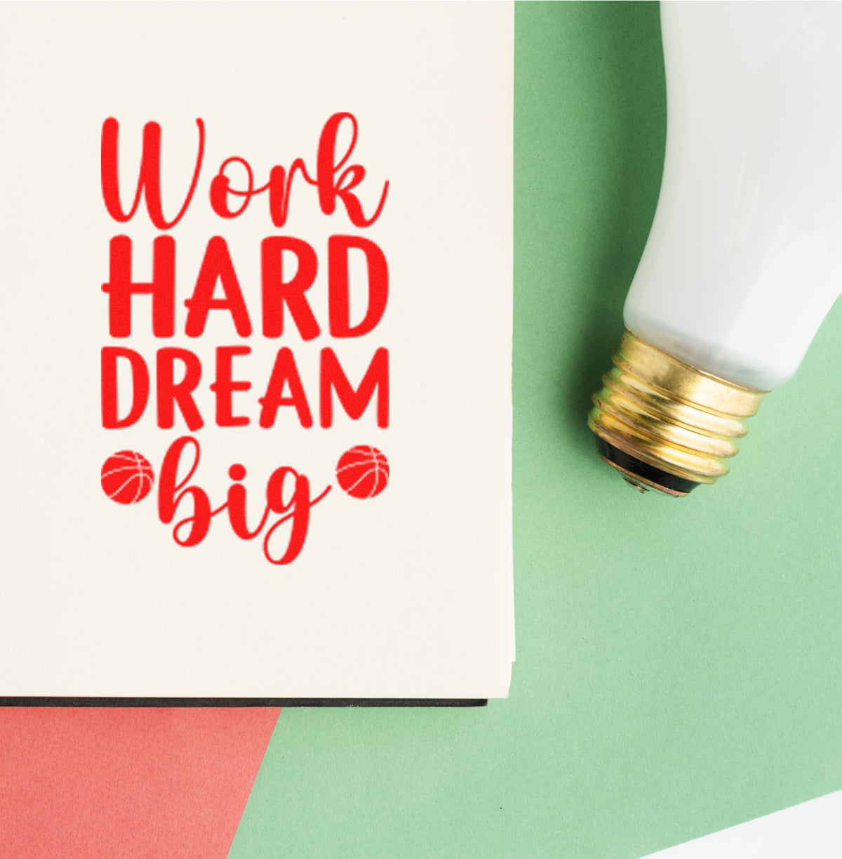 Red Work Hard Dream Big stamp beside white-and-gold seal applicator on mint green and coral background.