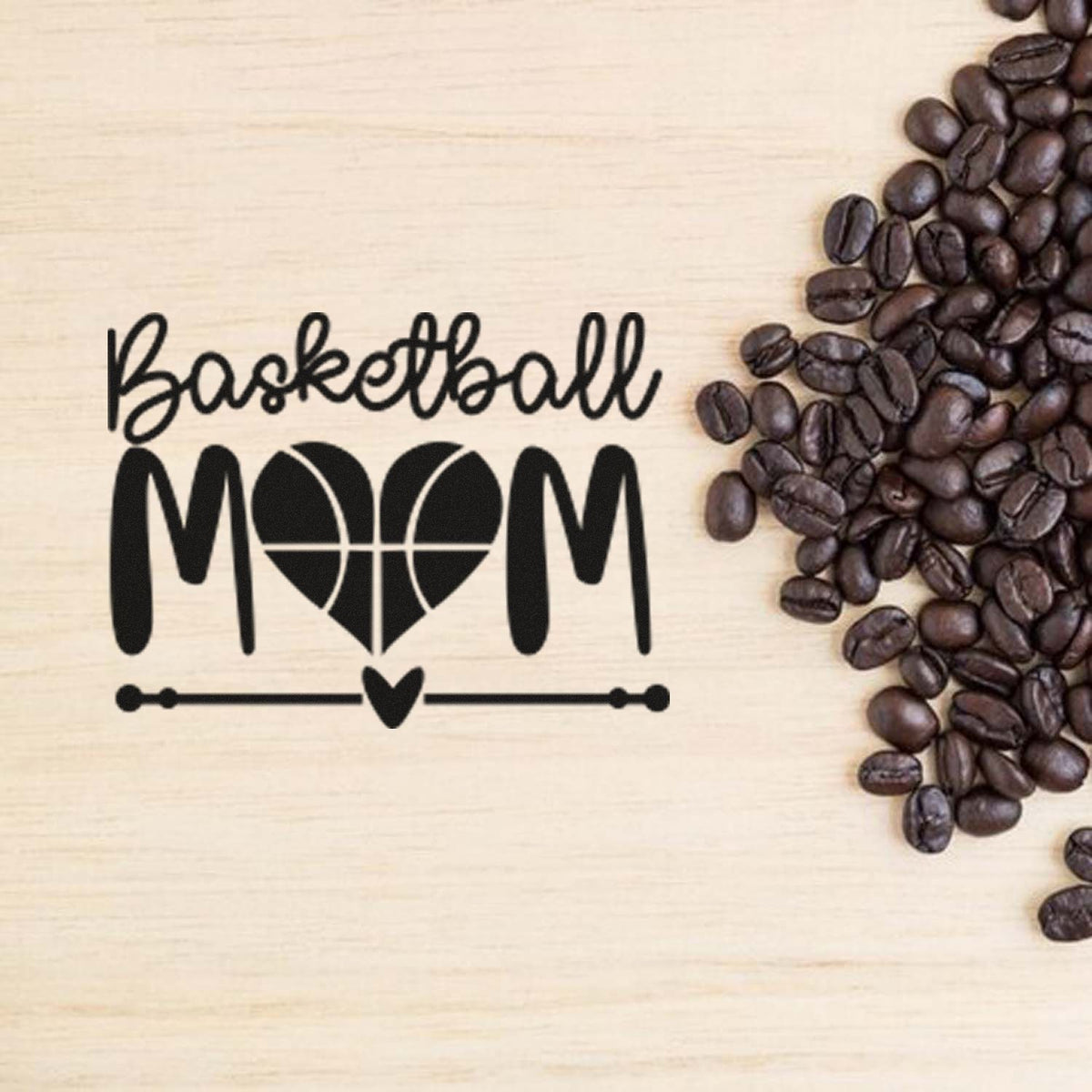 Black Basketball MOM stamp/seal design on light wood, with heart basketball graphic and dark coffee beans.