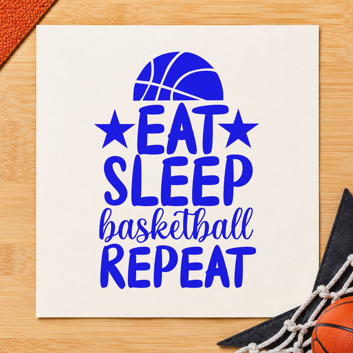 Eat Sleep Basketball Repeat craft stamp imprinted in blue ink on paper, a design suited to framed bedroom door.