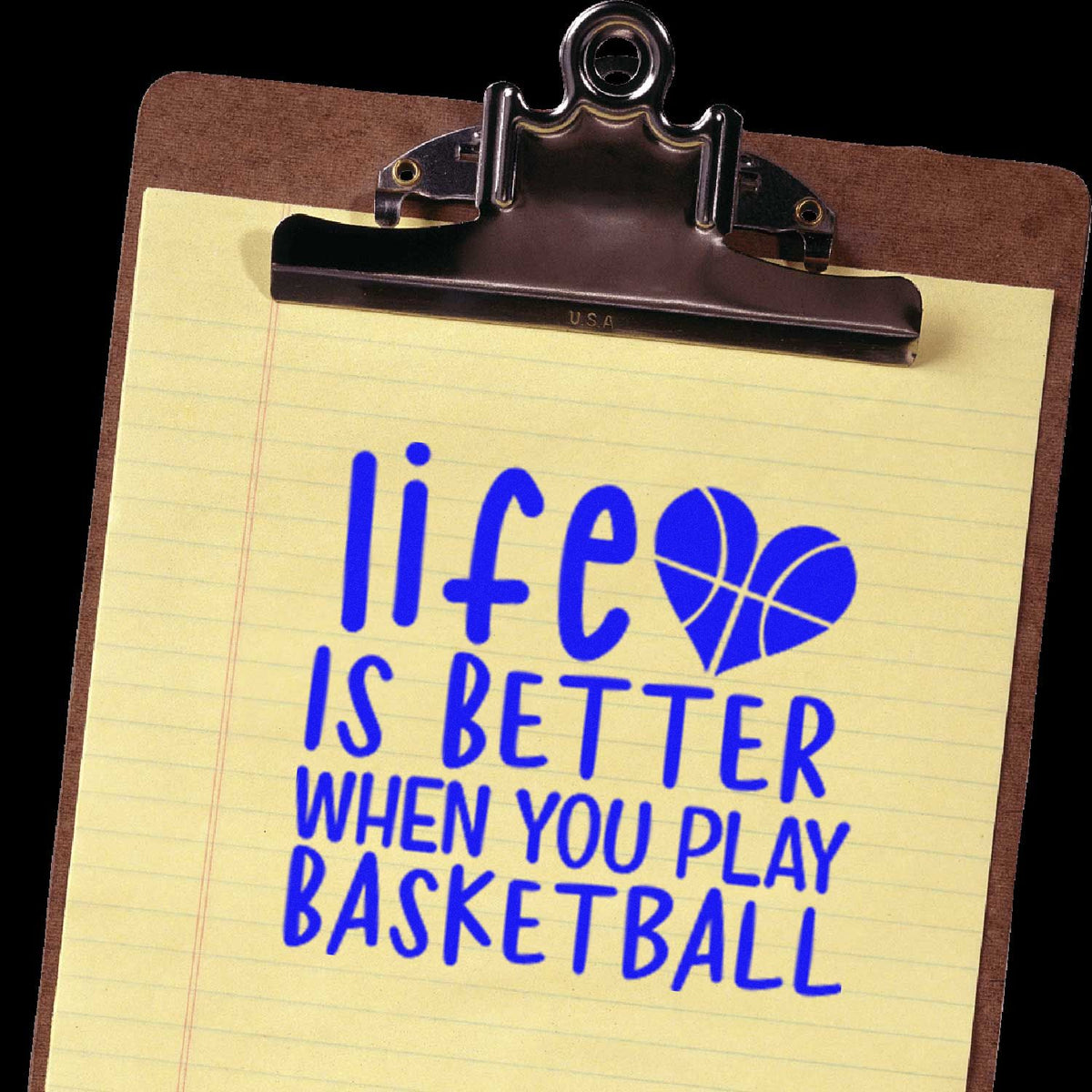 Blue basketball stamp on yellow notepad clipped to brown clipboard, reading Life is better when you play basketball with heart basketball icon.