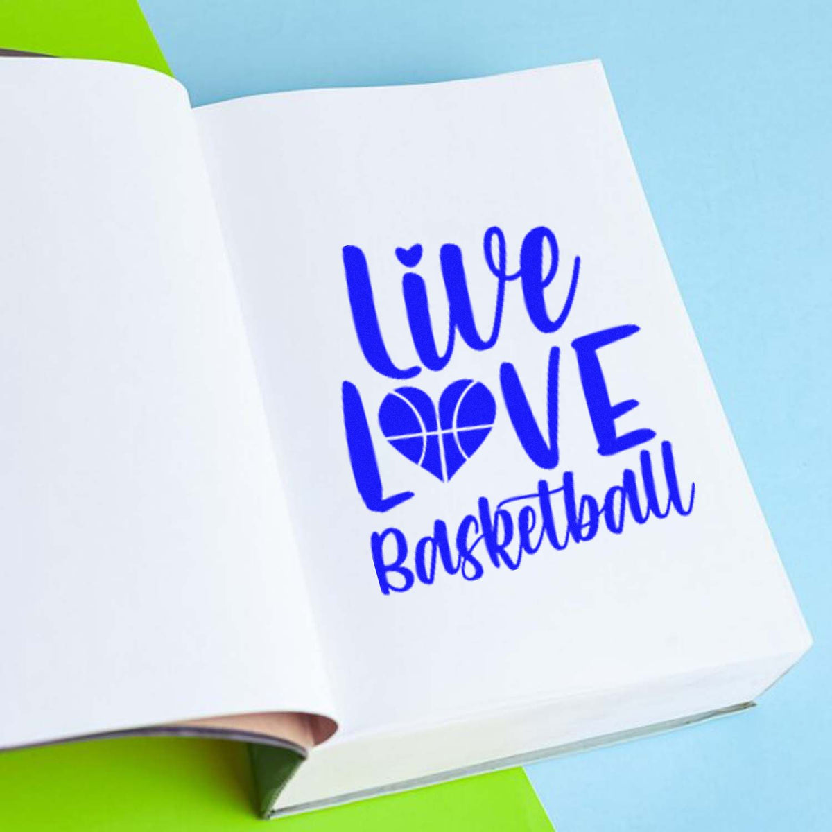Blue custom stamp seal reading Live Love Basketball on white paper, with heart basketball and cursive lettering.