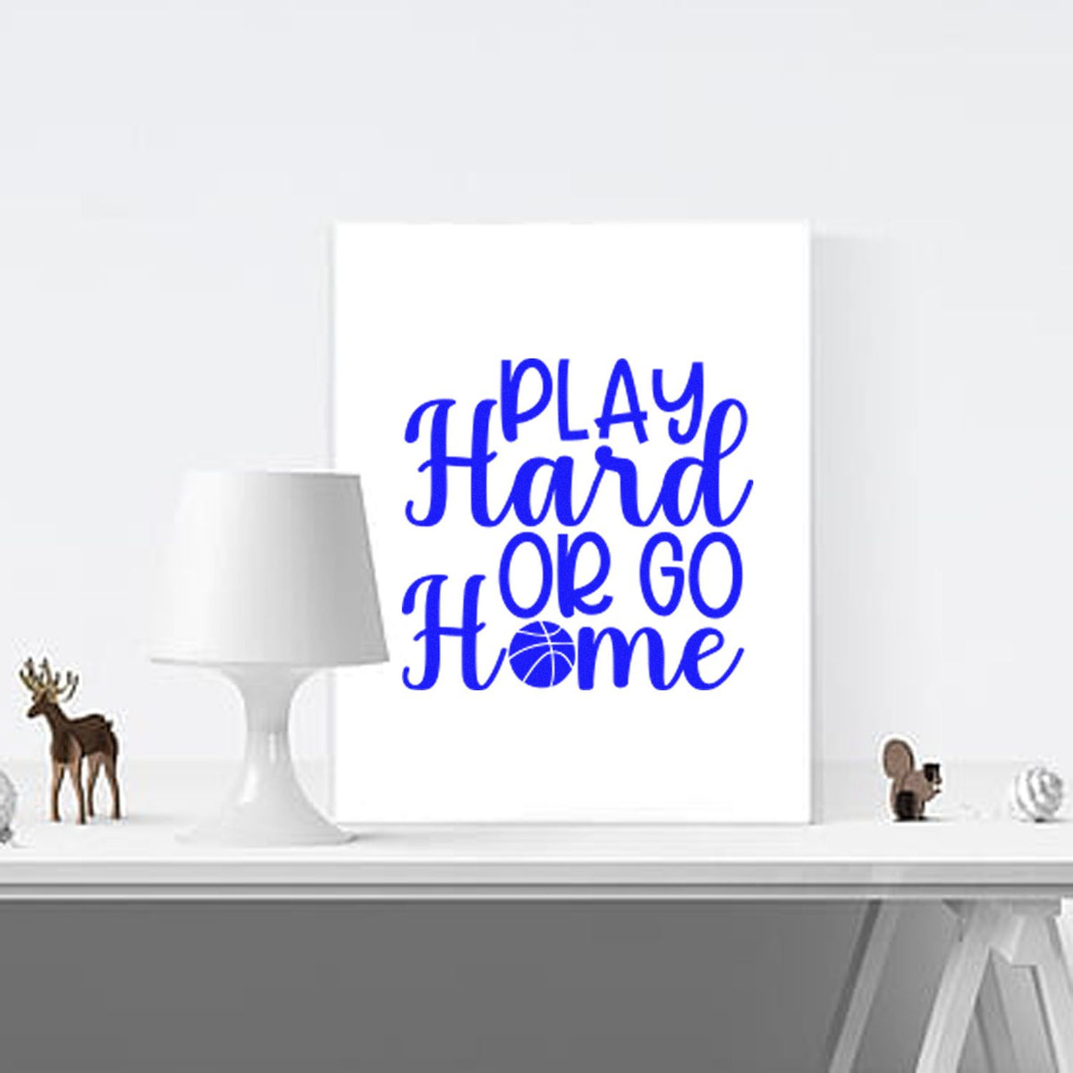 Blue Play Hard or Go Home stamp/seal design with basketball O on a white canvas and white lamp.
