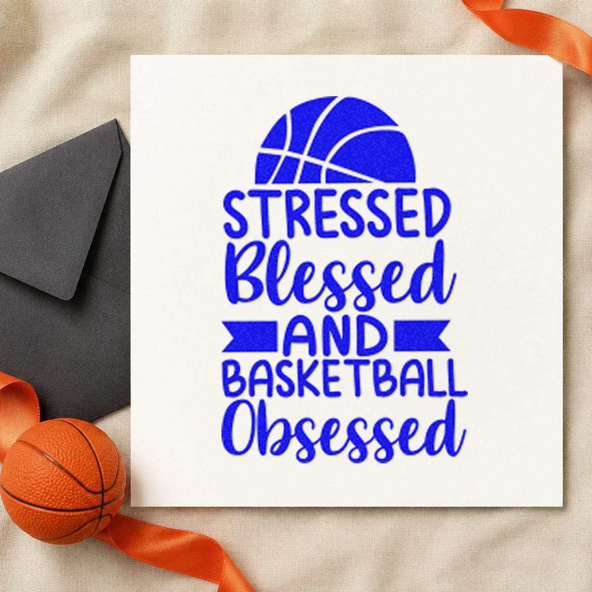 Stressed Blessed Basketball Obsessed craft stamp imprinted in blue ink on paper, a design suited to framed equipment room.