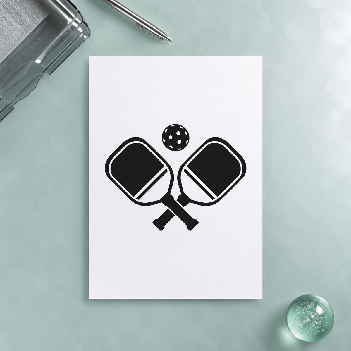 Crossed Pickleball Paddles Ball craft stamp imprint in black ink on a handmade project, one idea being welcome kit gift tags.