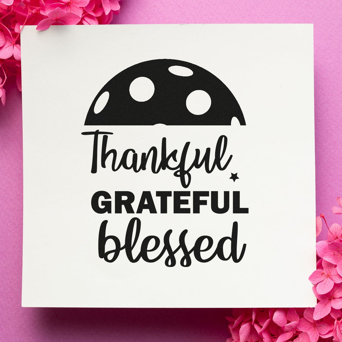 Black thankful grateful blessed stamp and seal on white card, framed by bright pink flowers.