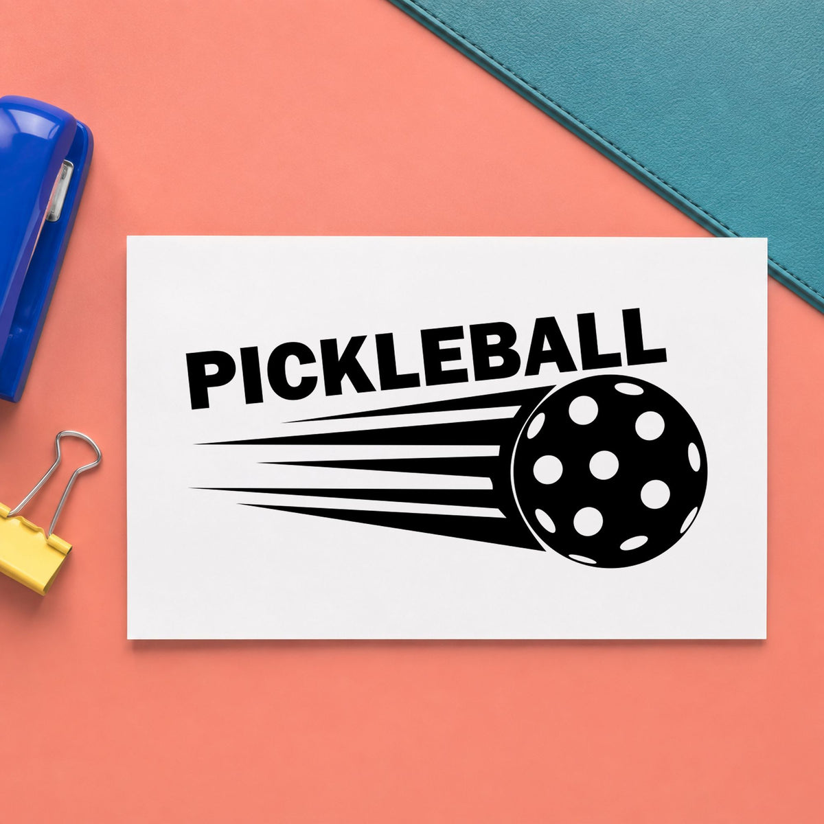 Pickleball Speeding Ball Graphic craft stamp imprint in black ink on a handmade project, one idea being loaner paddle tags.