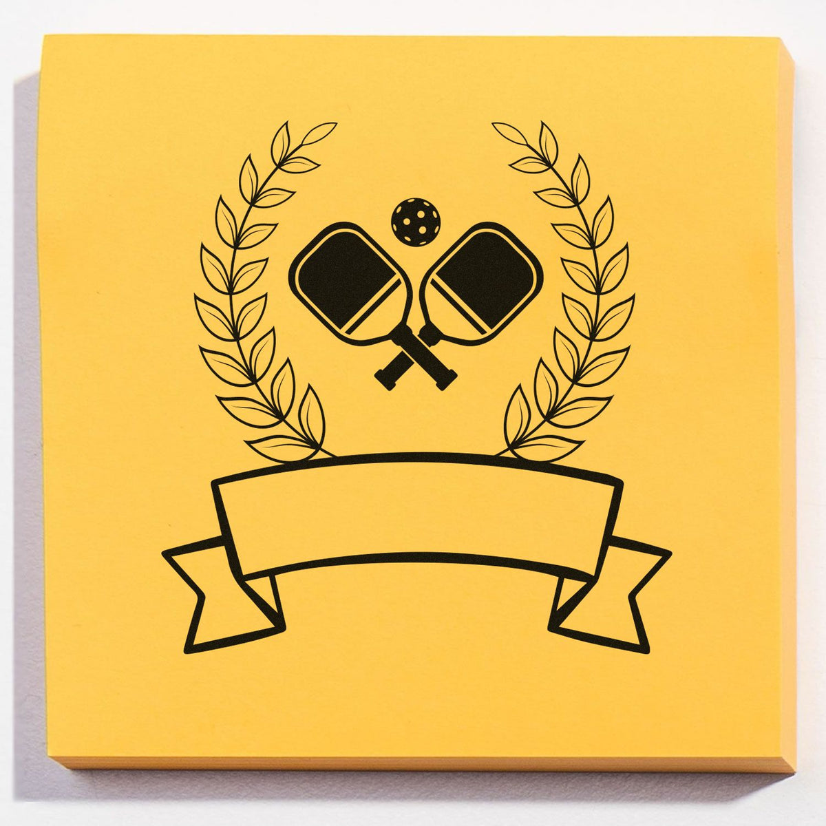 Yellow stamp and seal design with black pickleball paddles, laurel wreath, and banner emblem