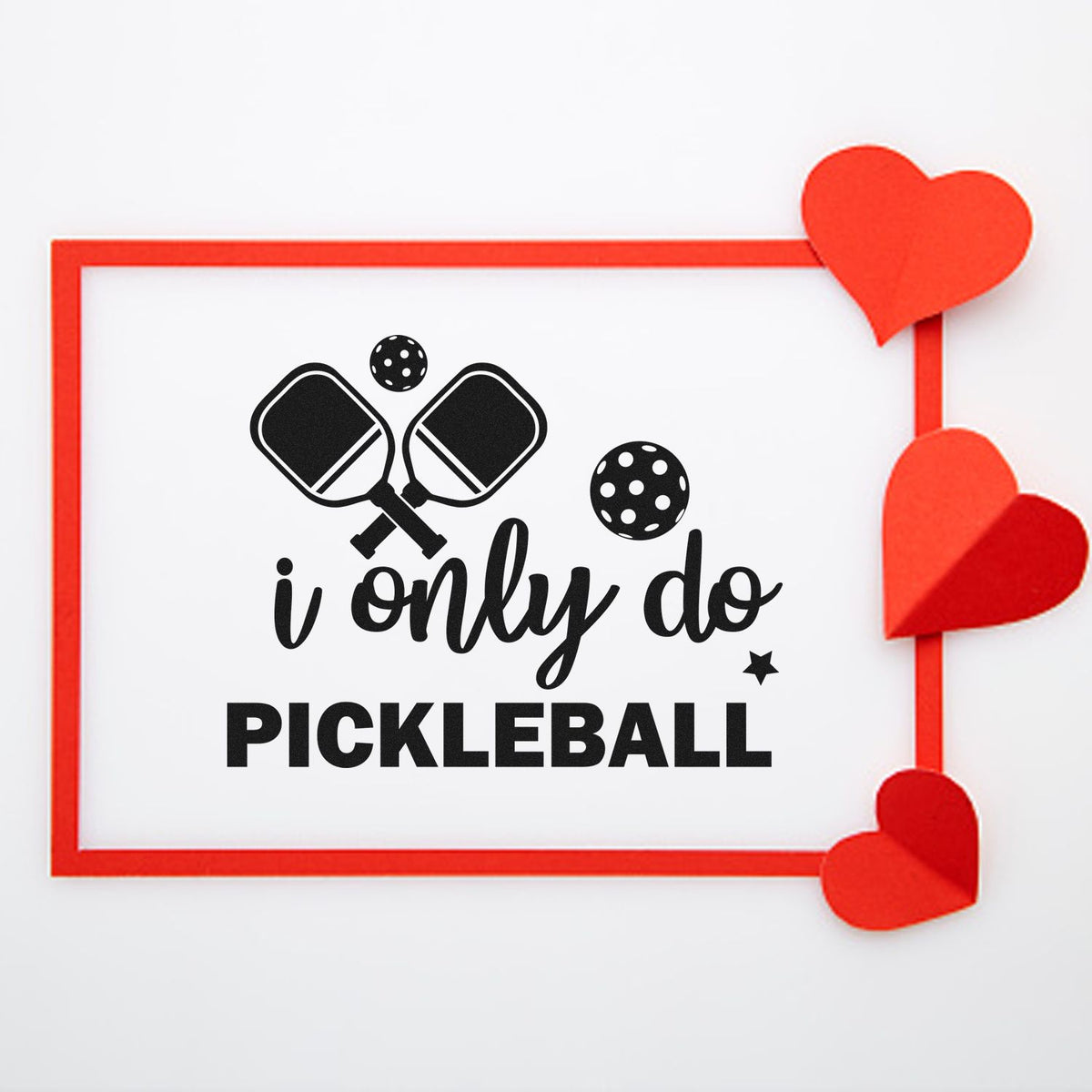 Pickleball stamp and seal with black paddles and balls, red border, and red heart corners on a white background.