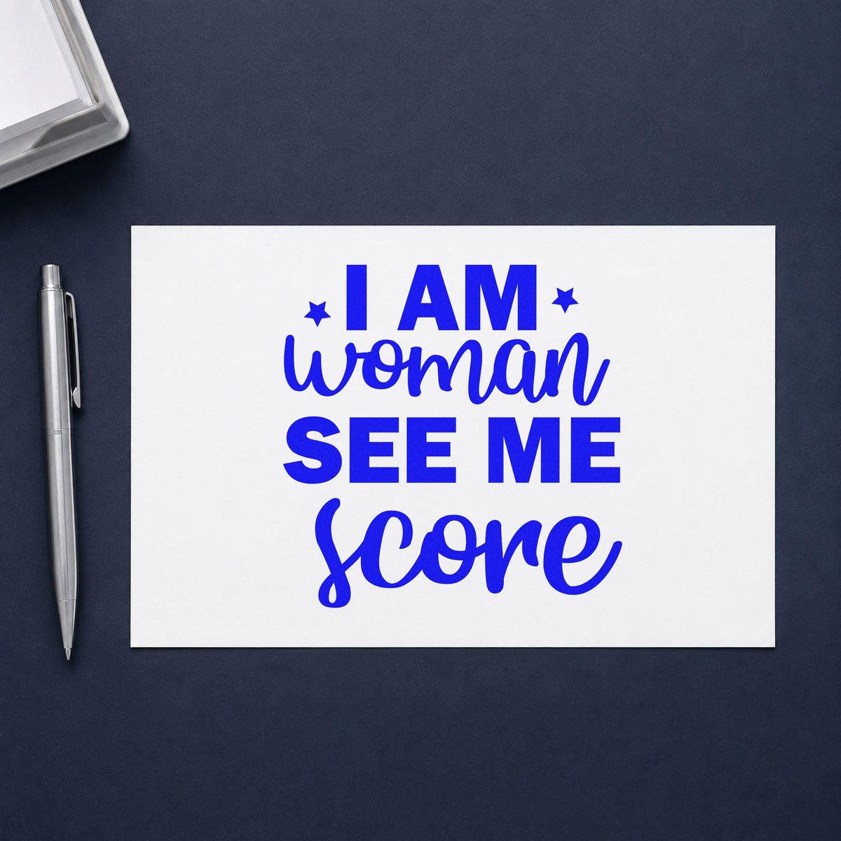 Woman See Me Score craft stamp in blue ink on cardstock, an easy option for clinic tee printing.