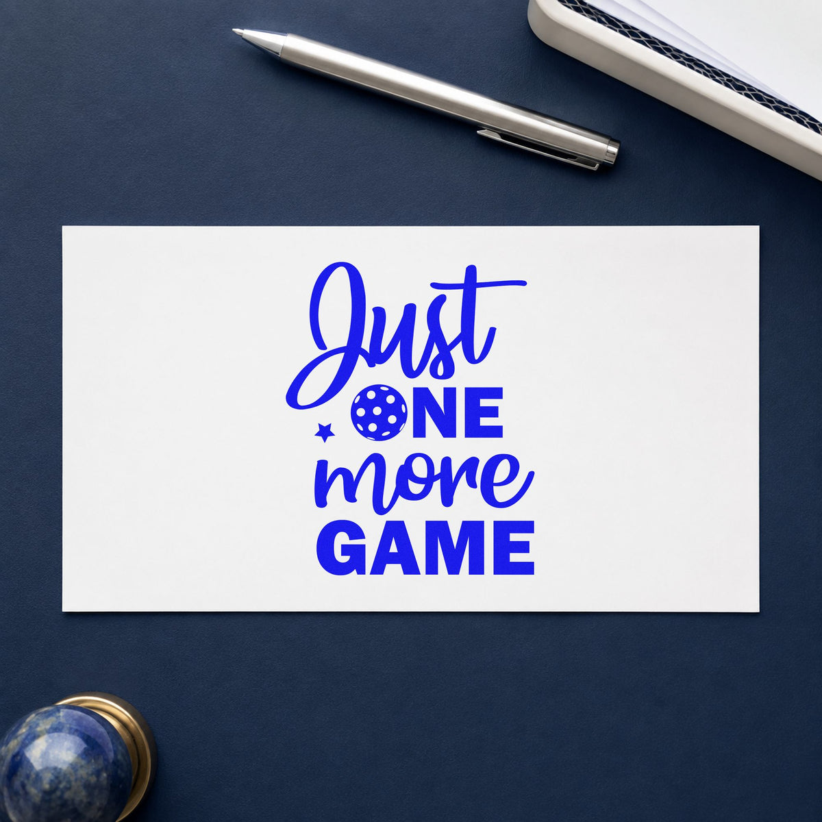 Just One More Game craft stamp in blue ink on cardstock, an easy option for bench cover printing.