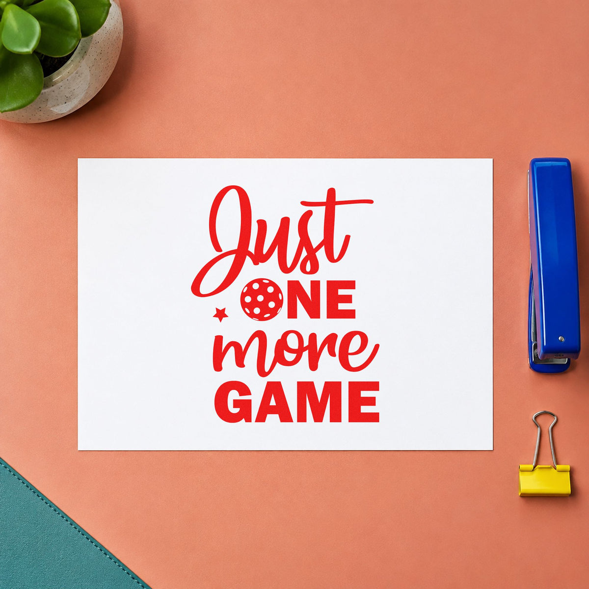Just One More Game rubber stamp shown in red ink, stamped for projects such as bin paddle labels.