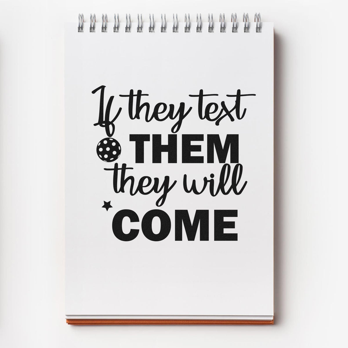 White spiral notebook with black quote If they text THEM they will COME, plus stamp-style polka-dot seal and star accents.