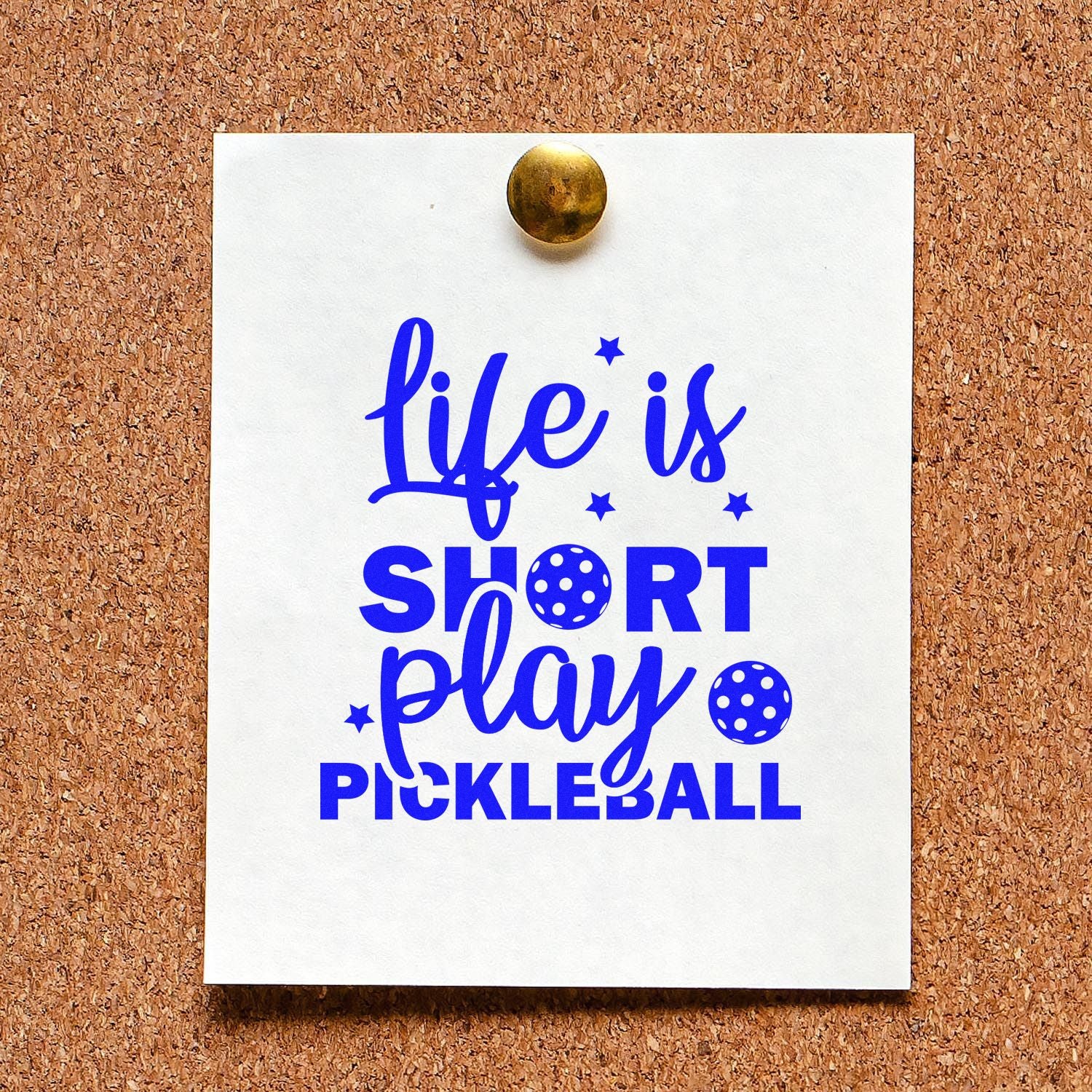 Blue pickleball stamp and seal design on white card with stars, pinned to corkboard with brass tack.
