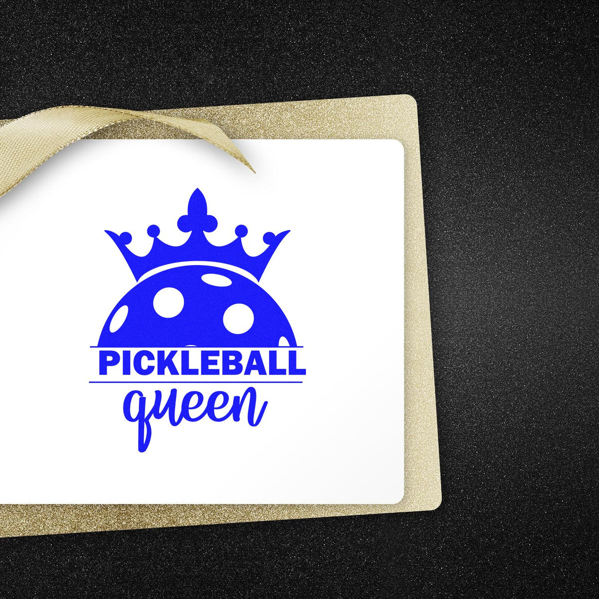 Blue pickleball queen stamp and seal with crown on white card, layered over glittery gold backing and ribbon.
