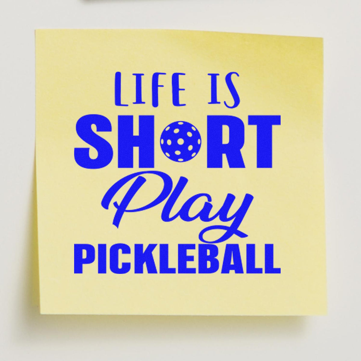 Yellow square stamp seal with blue text reading Life is short, play pickleball and a pickleball dot icon.