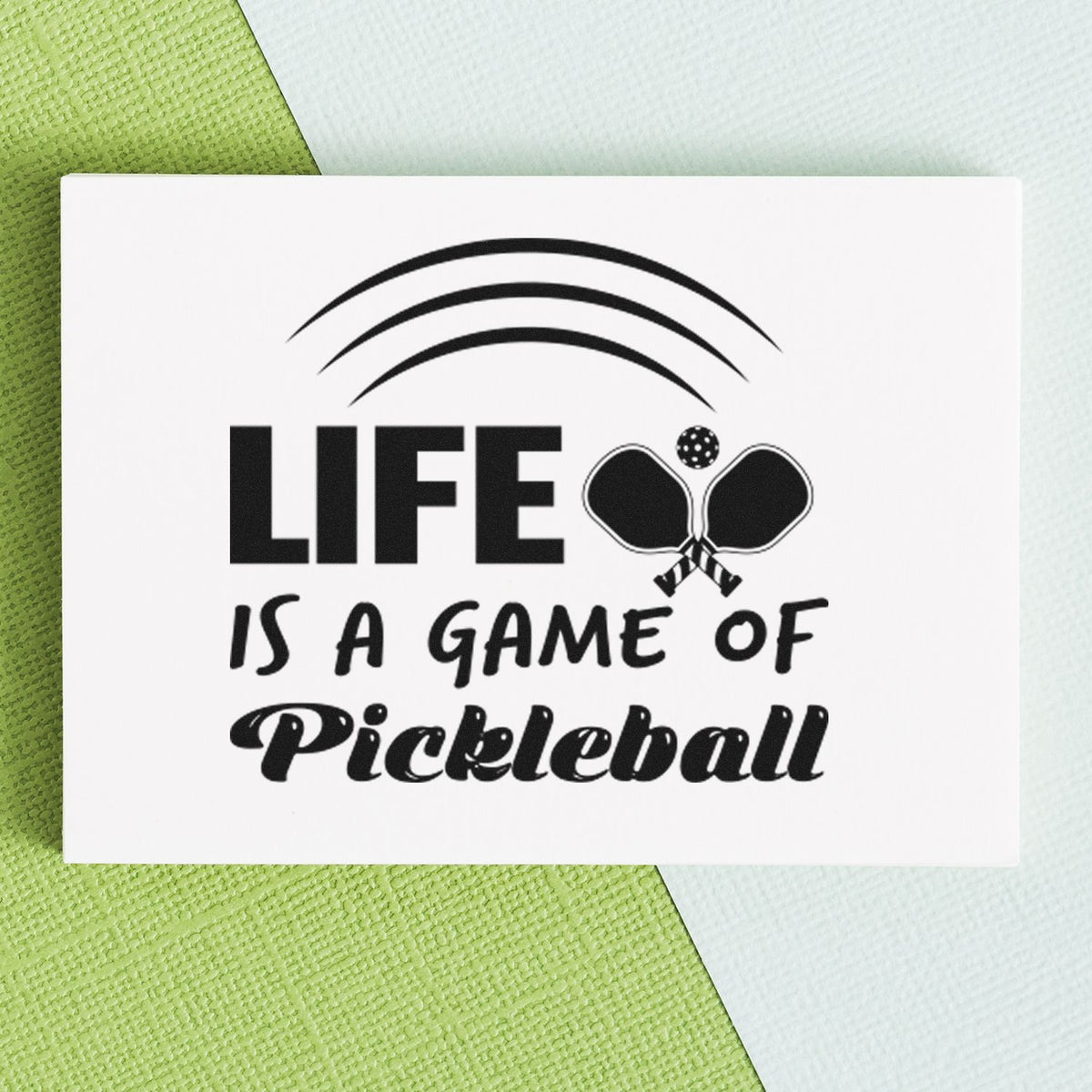 Life Is A Game Of Pickleball Stamp - Premium Vintage Pro Wooden imprint stamped in black ink. LIFE IS A GAME OF Pickleball appears with crossed paddles and three curved lines above.