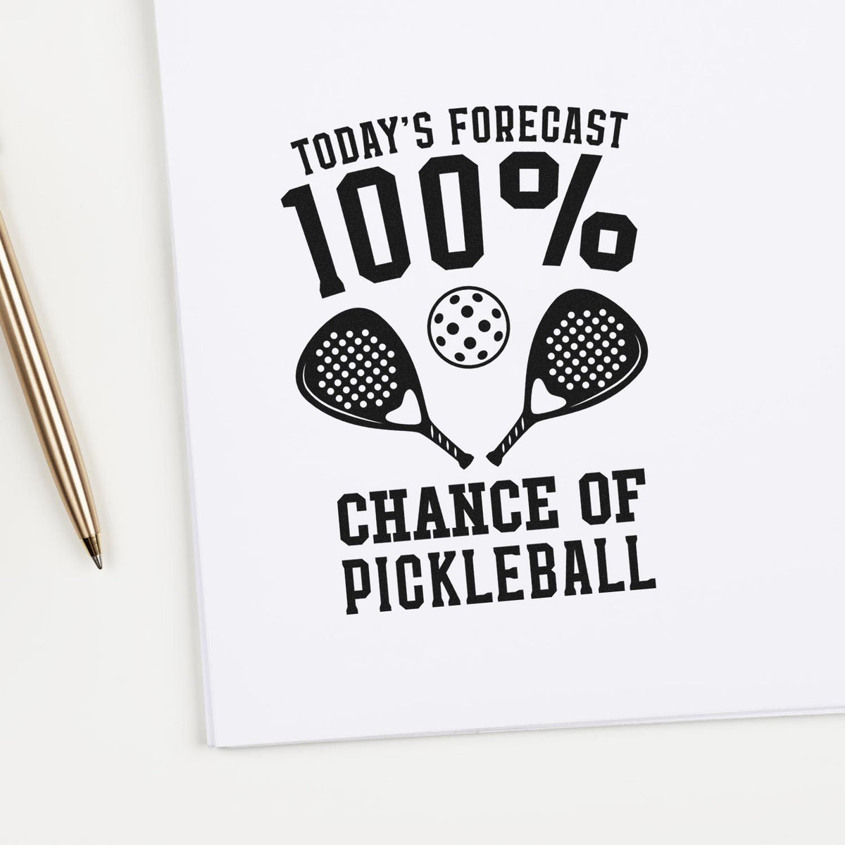 Black stamp/seal design on white page reading Todays Forecast 100% Chance of Pickleball with two paddles.