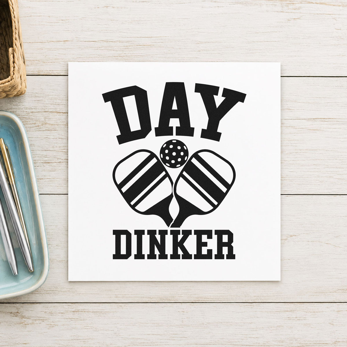 Day Dinker Crossed Paddles craft stamp imprint in black ink on a handmade project, one idea being arrival gift tags.