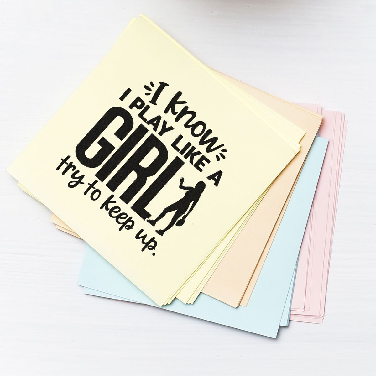 Pastel stamp and seal sheets with bold black I know I play like a girl text and athlete silhouette.