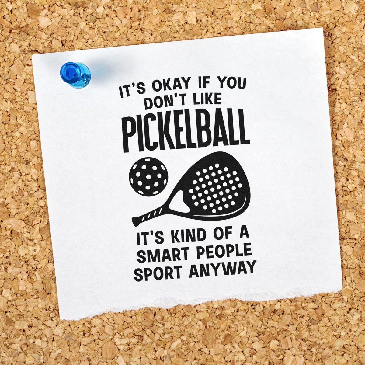Black pickleball stamp and seal design on white paper, with paddle and ball graphic, pinned to a corkboard with blue tack.