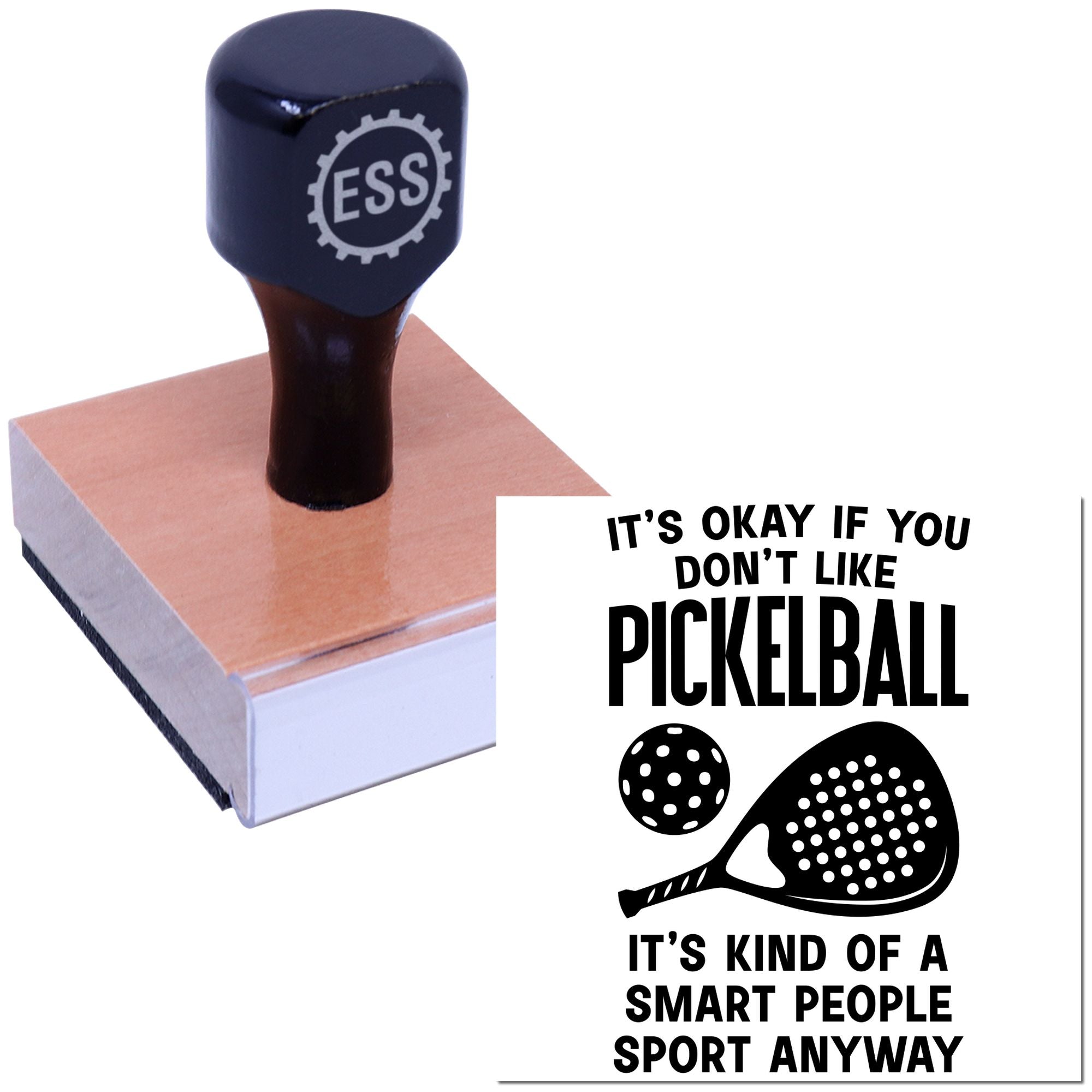Navy ESS rubber stamp seal on a wooden block beside a black-and-white pickleball slogan print.