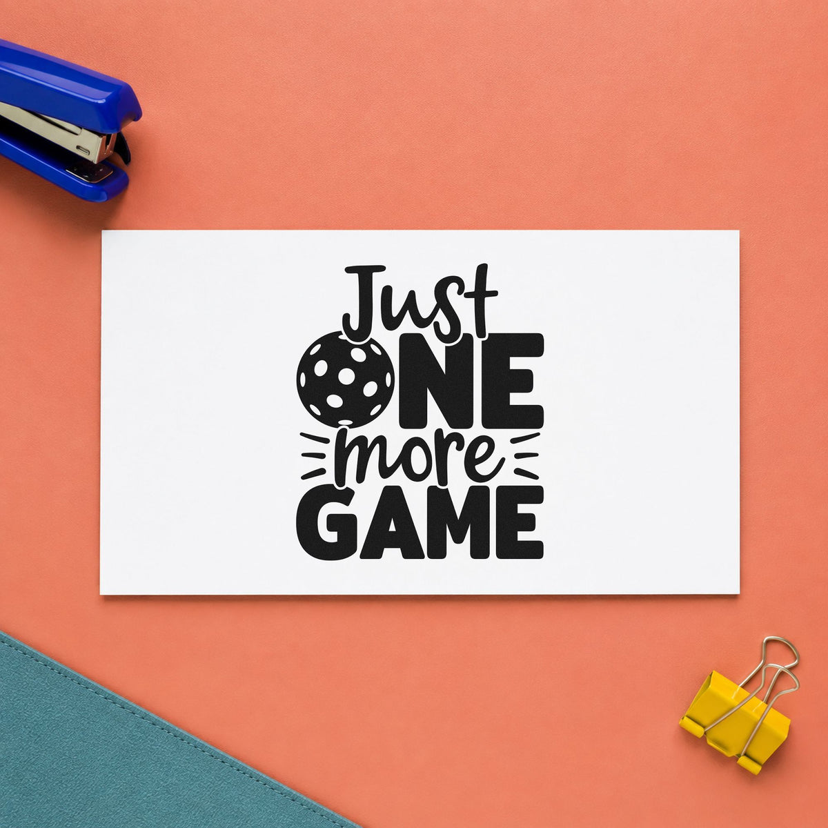 Just One More Game craft stamp imprint in black ink on a handmade project, one idea being glow ball gift tags.