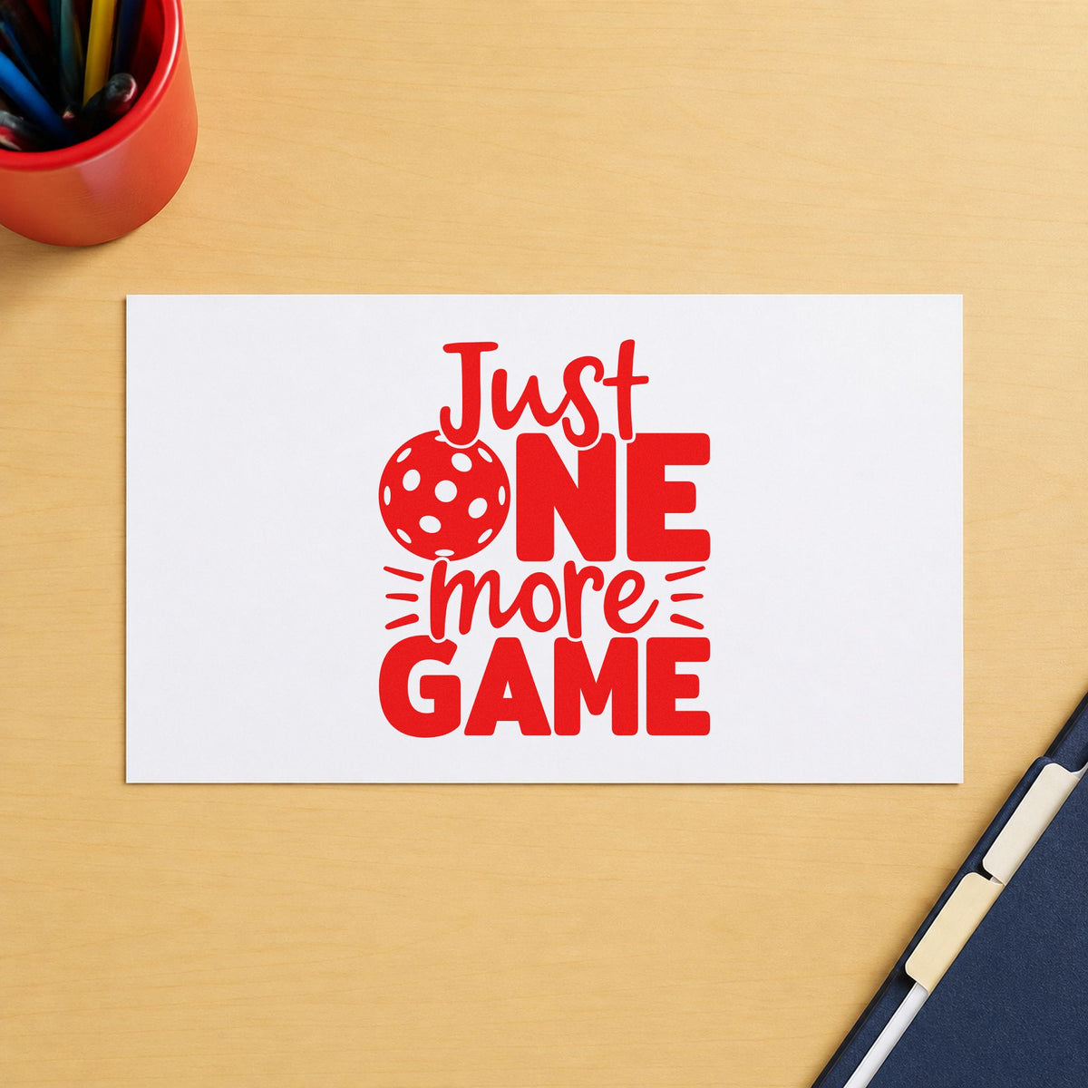 Just One More Game rubber stamp shown in red ink, stamped for projects such as bin light labels.