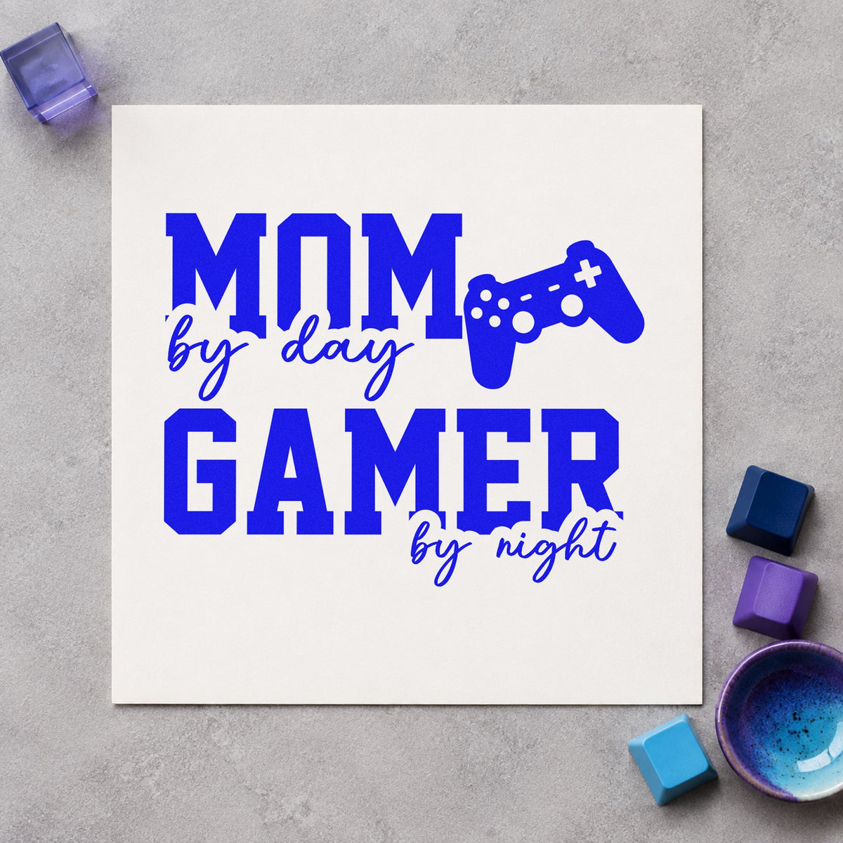 Mom Day Gamer Night craft stamp imprinted in blue ink on paper, a design suited to framed living shelf.