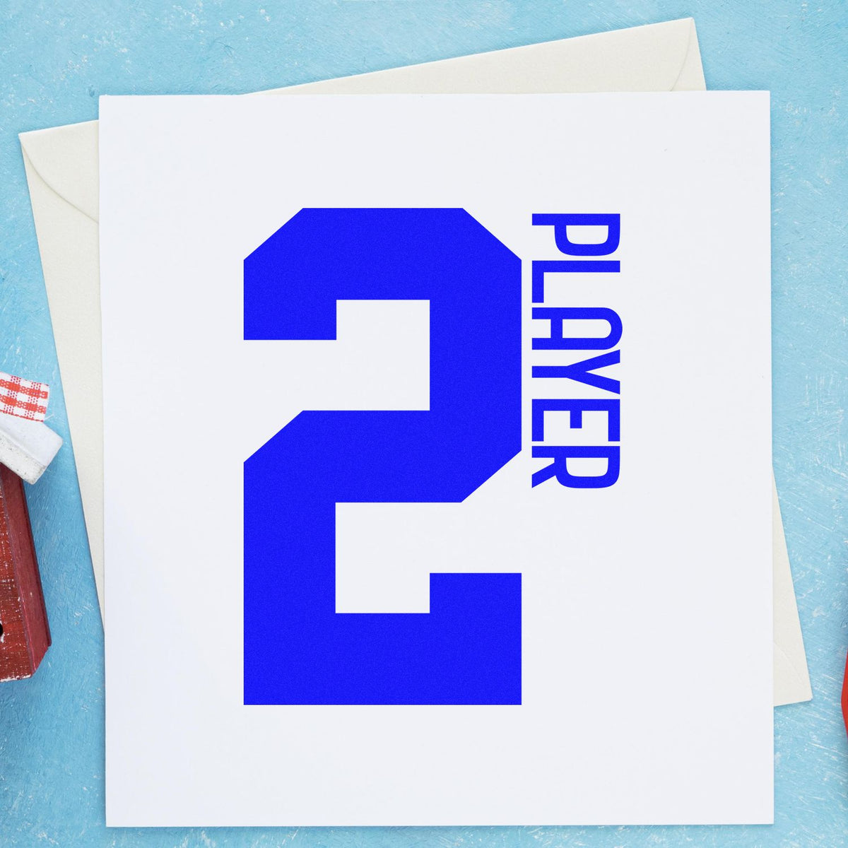 Blue custom stamp and seal with large number 2 and vertical PLAYER on a white card, on a light blue background.