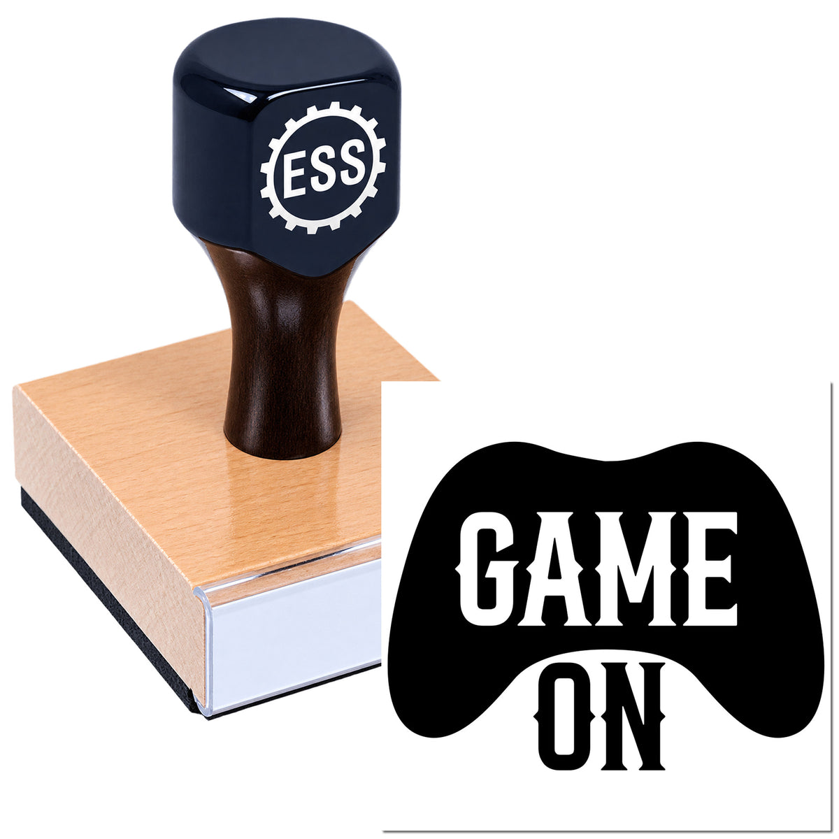 Black rubber stamp with ESS logo on a pink wood block, imprinting a GAME ON gamepad-shaped seal.