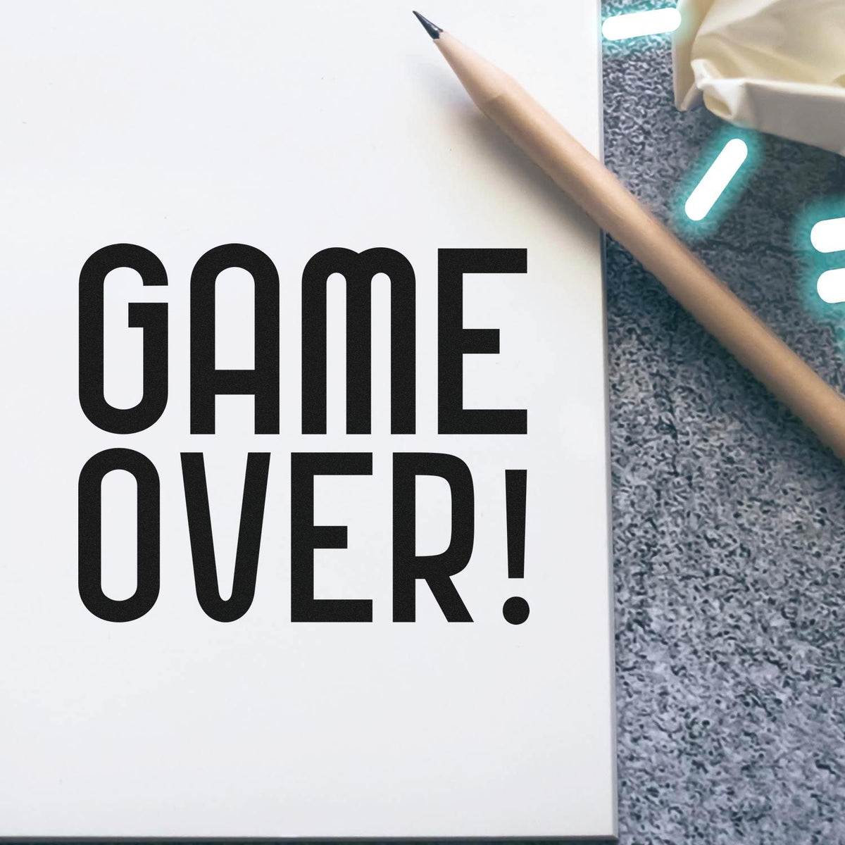 Black GAME OVER stamp on white paper with pencil, for stamp and seal products.