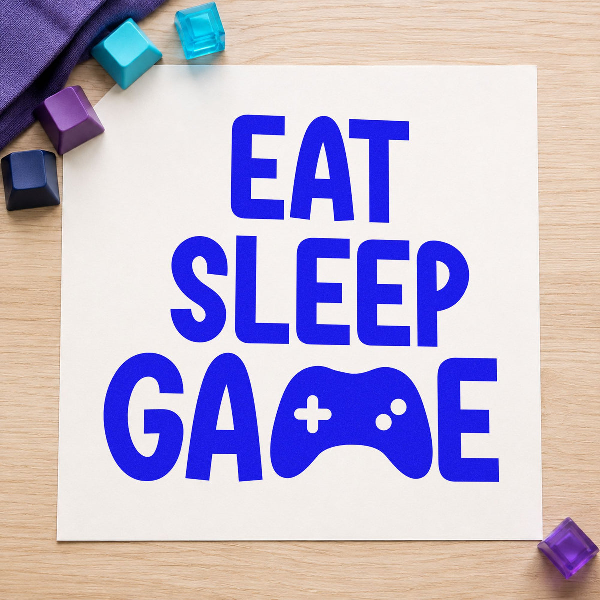 Eat Sleep Game Controller craft stamp imprinted in blue ink on paper, a design suited to framed stream corner.
