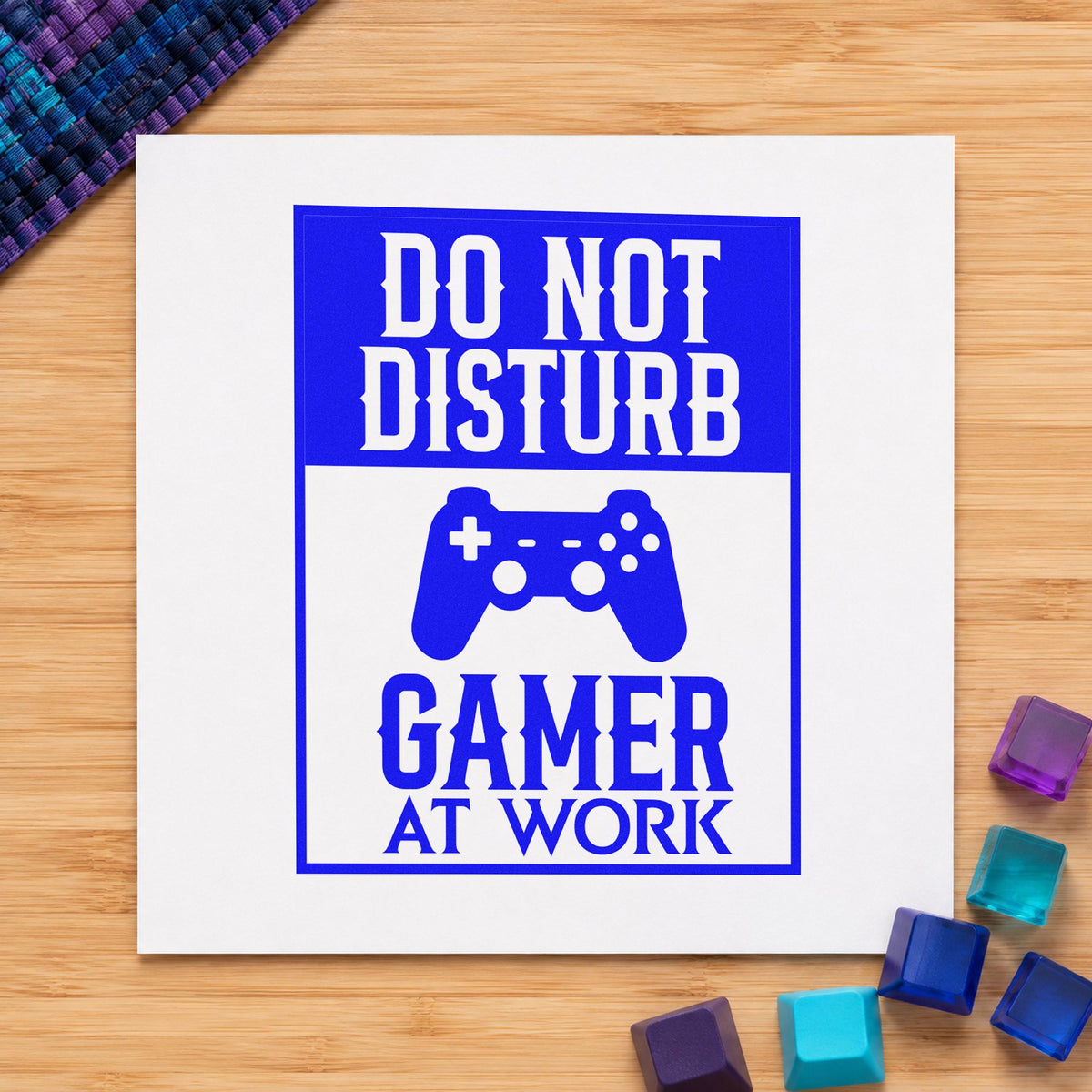 Do Not Disturb Gamer craft stamp imprinted in blue ink on paper, a design suited to framed studio door.
